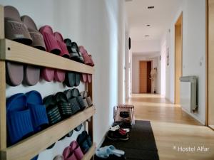 a room with a bunch of shoes on a wall at Hostel Alfar in Sarajevo