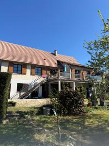 a large house with a porch and a balcony at Peaceful apartment in Vierzon