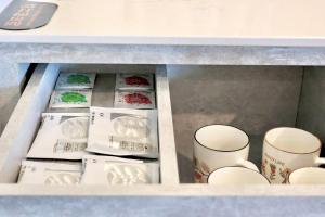 a drawer filled with white dishes and cups at 芙蘿拉萃旅 in Taitung City