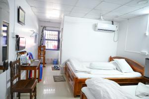 a hospital room with two beds and a desk at Banalata Resort in Jaypur
