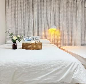 a bedroom with a large bed with white sheets at 루나스테이 in Seoul