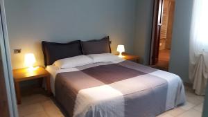 a bedroom with a large bed with two lamps on tables at Casa Maria Teresa in Cannero Riviera +64 photos