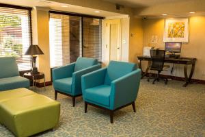 a waiting room with blue chairs and a desk at Days Inn by Wyndham Newark Wilmington in Newark