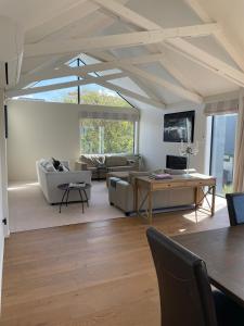 a living room with a couch and a table at Perfection on Park Lane in Timaru