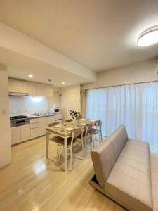a kitchen and dining room with a table and a couch at TIC HOTEL Marunouchisakae in Nagoya