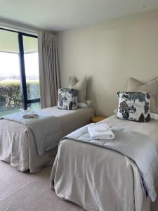 two beds sitting next to each other in a room at Perfection on Park Lane in Timaru
