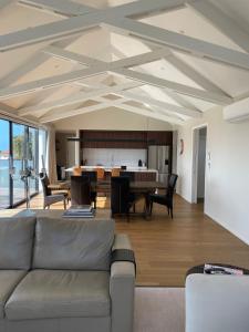 a living room with a couch and a table at Perfection on Park Lane in Timaru