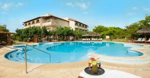 a large swimming pool in front of a building at Grand Palladium Imbassaí Resort & Spa - All Inclusive in Imbassai