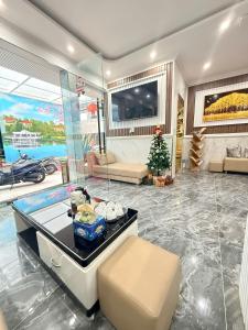 a living room with a couch and a christmas tree at Nghia Lan Hotel - Dalat Market in Da Lat