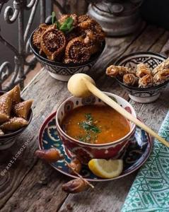 a bowl of soup on a wooden table with bowls of food at Majestic Room in Agadir +6 photos