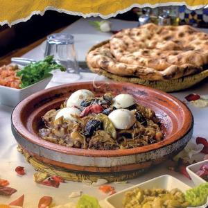 a bowl of food on a table with two pies at Majestic Room in Agadir