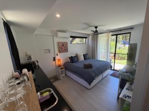 a bedroom with a bed and a living room at Carnarvon Castle Eagle Bay in Dunsborough