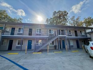an apartment building with a staircase in a parking lot at La Casa Motel, Los Angeles - Burbank Airport in Sun Valley
