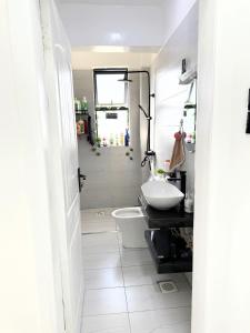 a bathroom with a sink and a toilet in it at Kitusuru staycation in Wabuga +6 photos