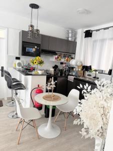 a kitchen with a table and chairs in a room at Kitusuru staycation in Wabuga