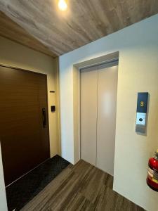 an empty room with a door and a hallway at TIC HOTEL NAGOYA Station in Nagoya +18 photos