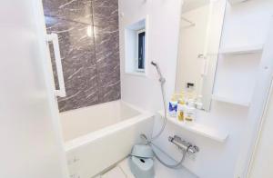a bathroom with a shower and a toilet and a sink at TIC HOTEL NAGOYA Station in Nagoya