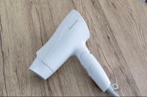 a white wii remote sitting on a wooden table at TIC HOTEL NAGOYA Station in Nagoya