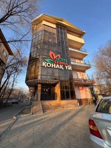 a building with a sign on the front of it at Гостиница TERRA in Almaty
