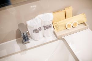 a counter with two white bags on a table at Quies Hotel in Krabi
