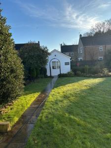 a yard with a house and a driveway at Boutique Rooms at The Ellesmere in Hornsea +3 photos