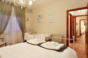 a bedroom with two beds and a chandelier at Adua Apartments in Montecatini Terme