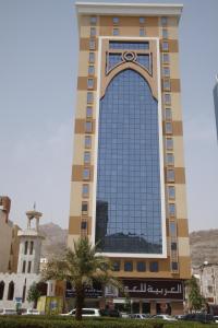 a tall building with a large glass window at Alolayan Plaza Hotel in Mecca