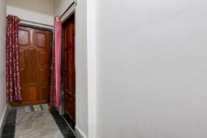 a hallway with two wooden doors and a floor at HOTEL O RAHAN APPARTMENT in New Town
