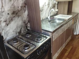a kitchen with a stove and a sink at Sarandí Lofts in Montevideo +63 photos