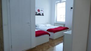 a small bedroom with a bed and a window at Apartment Mona in Sarajevo