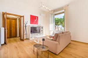 a living room with a couch and a tv at Ca'Mea 2 Vista Mare, vicino alla pista ciclabile in Imperia