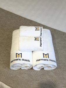 two white towels sitting on top of a table at Marmaris Rakat Hotel in Yakkasaray +38 photos