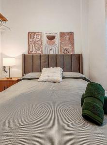 a bedroom with a large bed with green pillows on it at One Chaumel in Villena