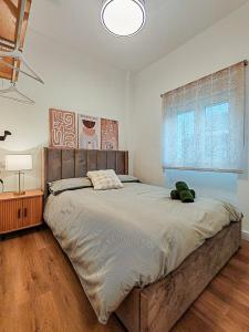 a bedroom with a large bed with a stuffed animal on it at One Chaumel in Villena