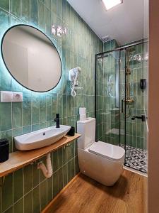 a bathroom with a sink and a toilet and a mirror at One Chaumel in Villena