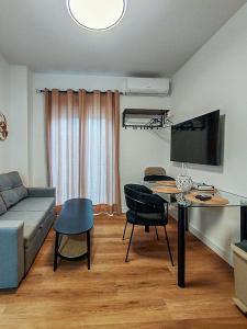 a living room with a couch and a table at One Chaumel in Villena