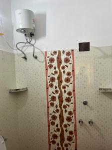 a shower curtain with animals on it in a bathroom at MR Homes in Cochin +3 photos