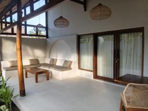 a living room with a bench and windows at ZENARA lombok - Boutique Adults Only in Kuta Lombok +60 photos