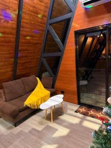 a living room with a couch and a yellow blanket at 33 0VG by Tasha's Place in Antipolo