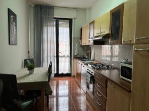 a kitchen with wooden cabinets and a counter top at Lake Garda in Gavardo