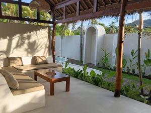 a living room with a couch and a table at ZENARA lombok - Boutique Adults Only in Kuta Lombok