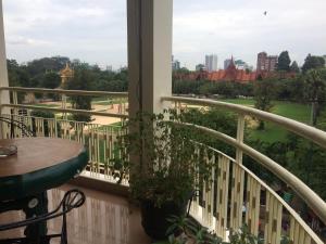 a balcony with a table and a view of the city at The Bright Lotus Guesthouse in Phnom Penh