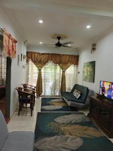 a living room with a couch and a table at HOMESTAY TASNIM in Bentong