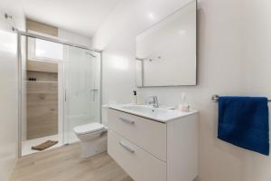a white bathroom with a sink and a toilet at Merlin 14 V1 in Playa Honda +19 photos