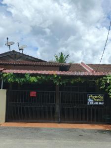 a building with a gate and a sign on it at HOMESTAY TASNIM in Bentong