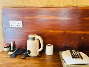 a coffee maker sitting on top of a table at Negombo Green Palace in Negombo
