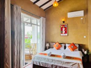a bedroom with a bed and a large window at Negombo Green Palace in Negombo
