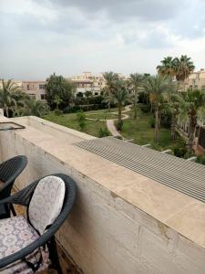 a pair of chairs sitting on the ledge of a balcony at فيلا in Sheikh Zayed