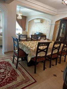 a dining room with a large table and chairs at فيلا in Sheikh Zayed