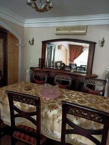 a dining room with a table and a mirror at فيلا in Sheikh Zayed +11 photos